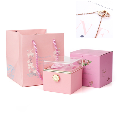 Heart-shaped necklace and rotating rose jewelry box