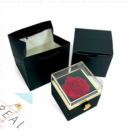 Heart-shaped necklace and rotating rose jewelry box