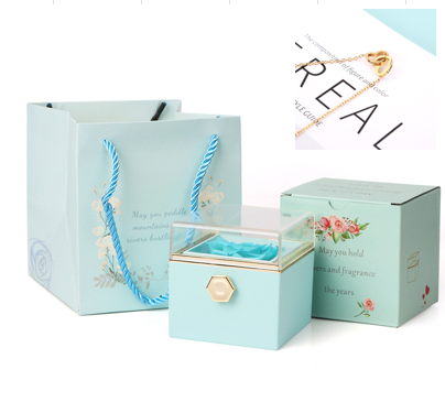 Heart-shaped necklace and rotating rose jewelry box