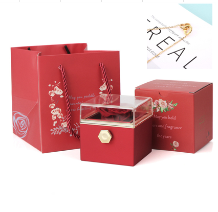 Heart-shaped necklace and rotating rose jewelry box